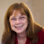 A woman with brown hair smiling