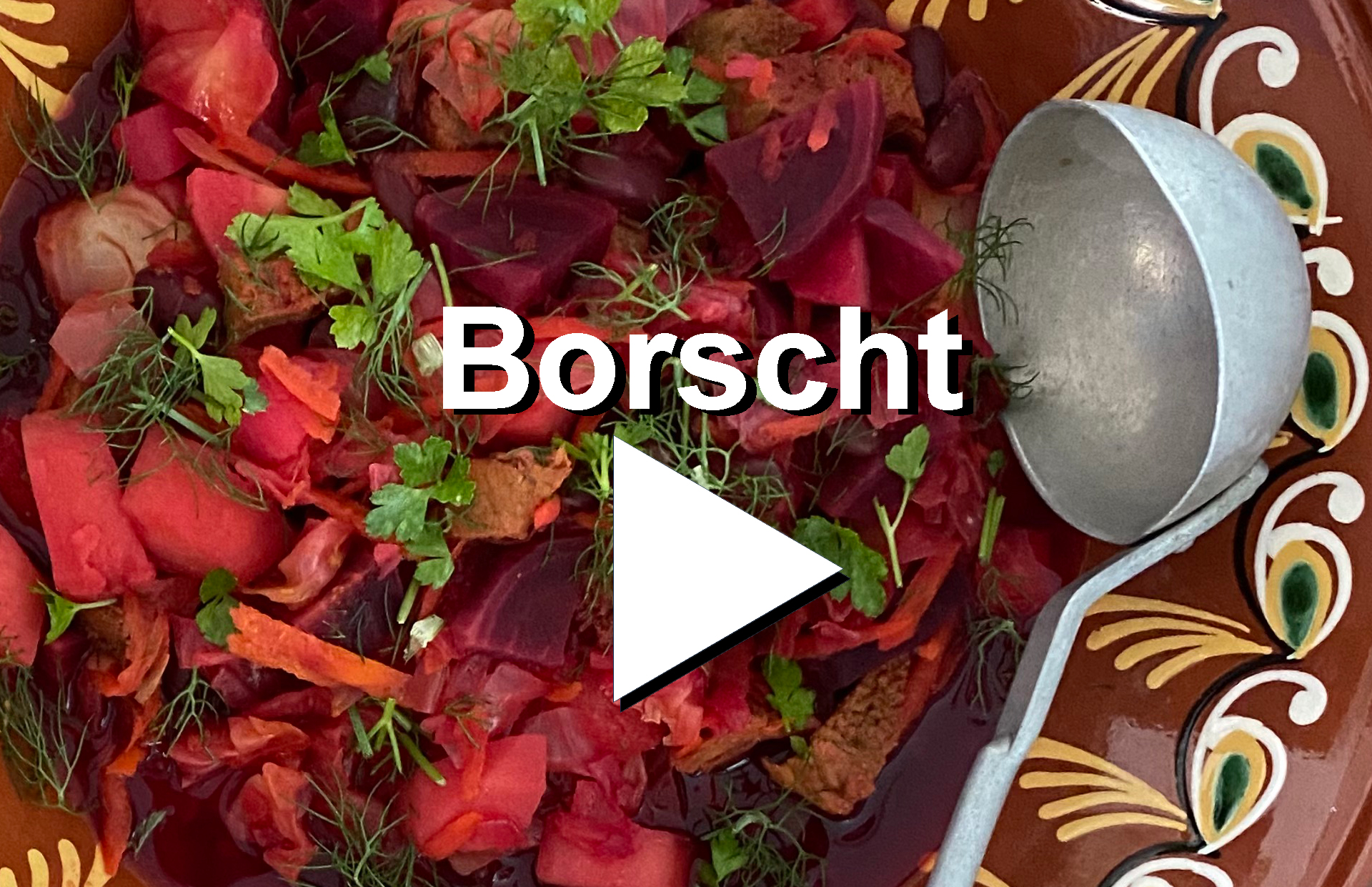 Close up of beet soup with ladle and video play button