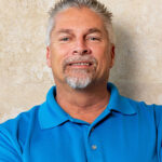 Man smiling in a blue shirt