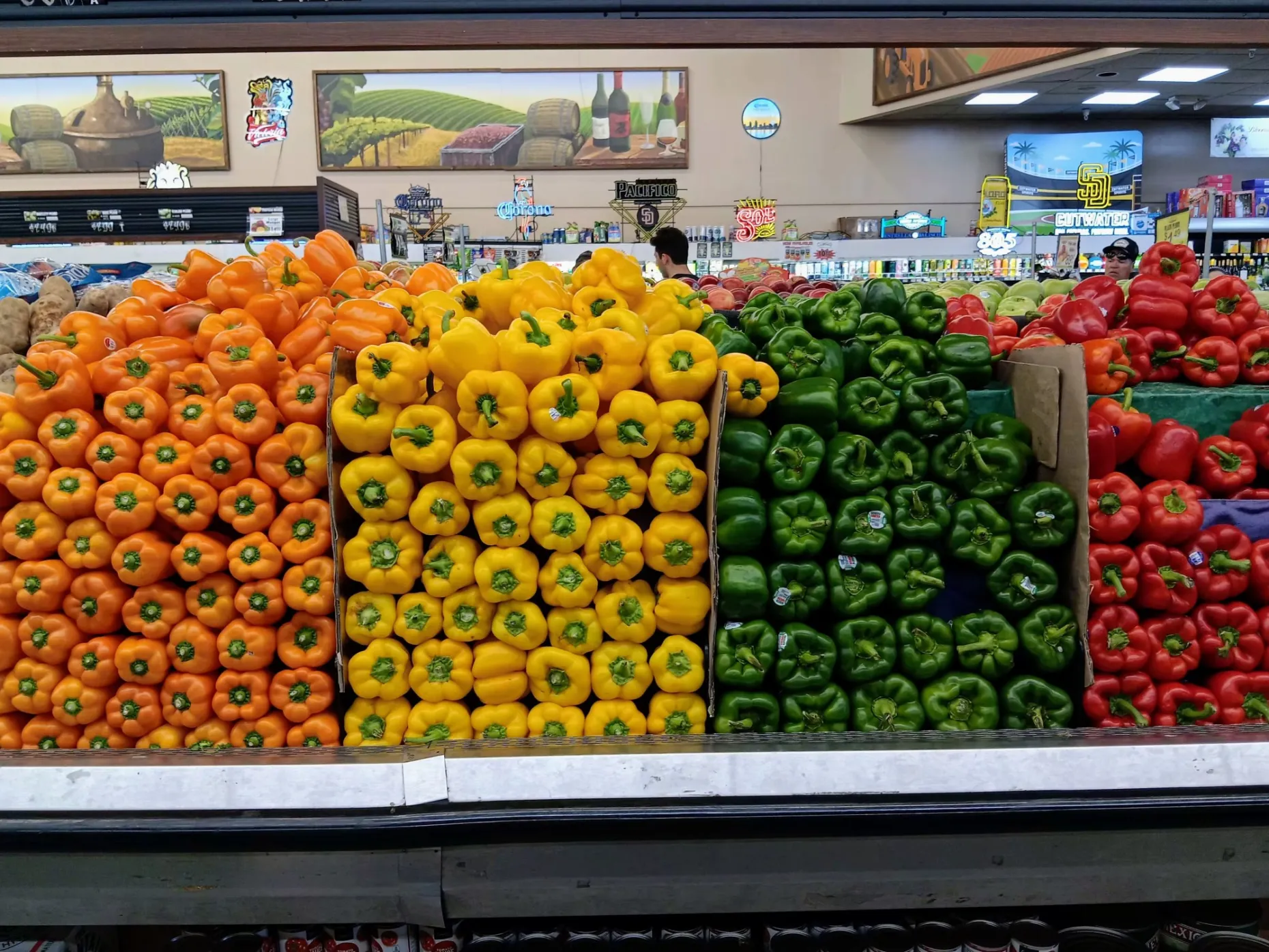 Photo of Bell Peppers stacked in a grocery shelf.