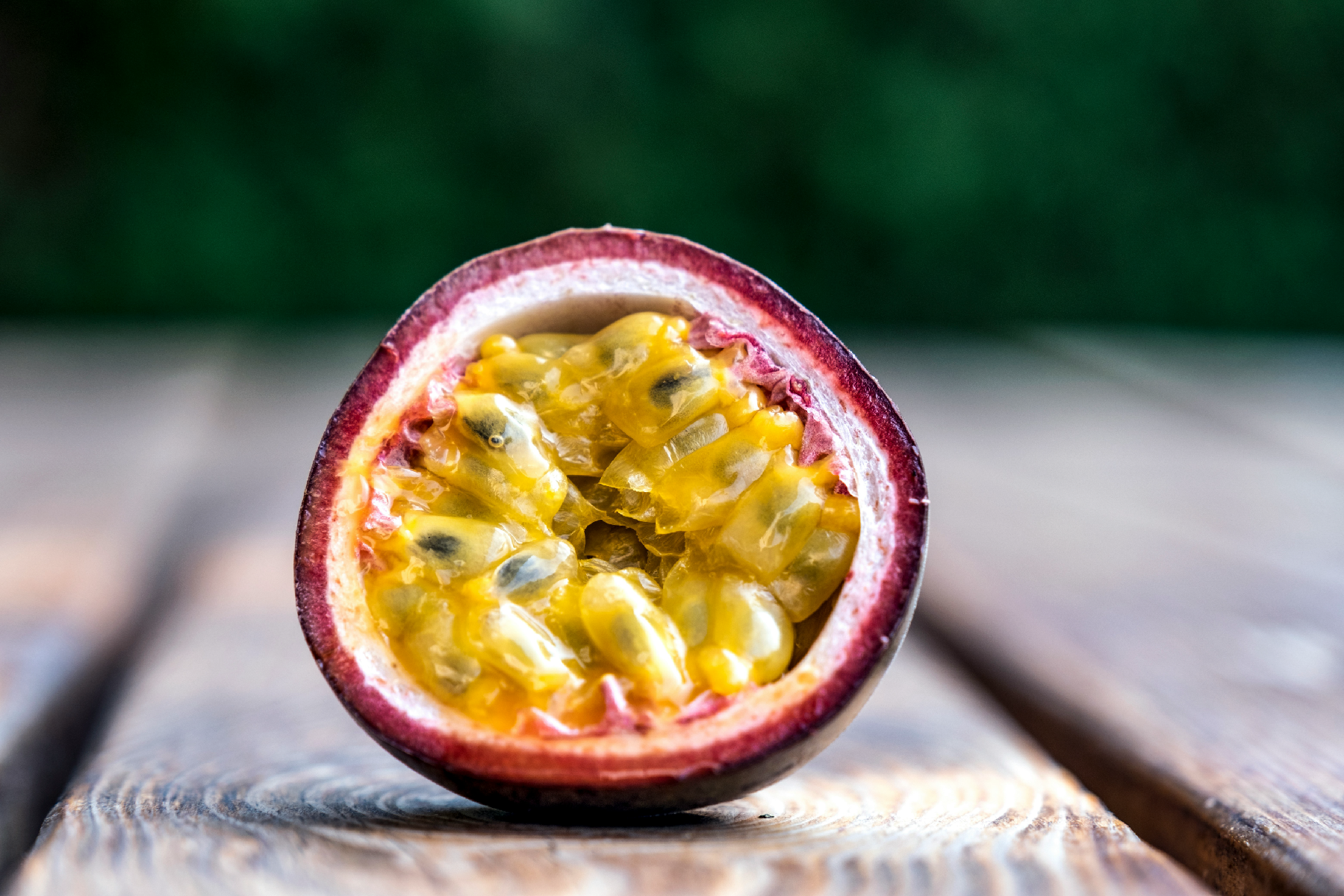 Photo of a Passion fruit sliced exposing it's pulp.